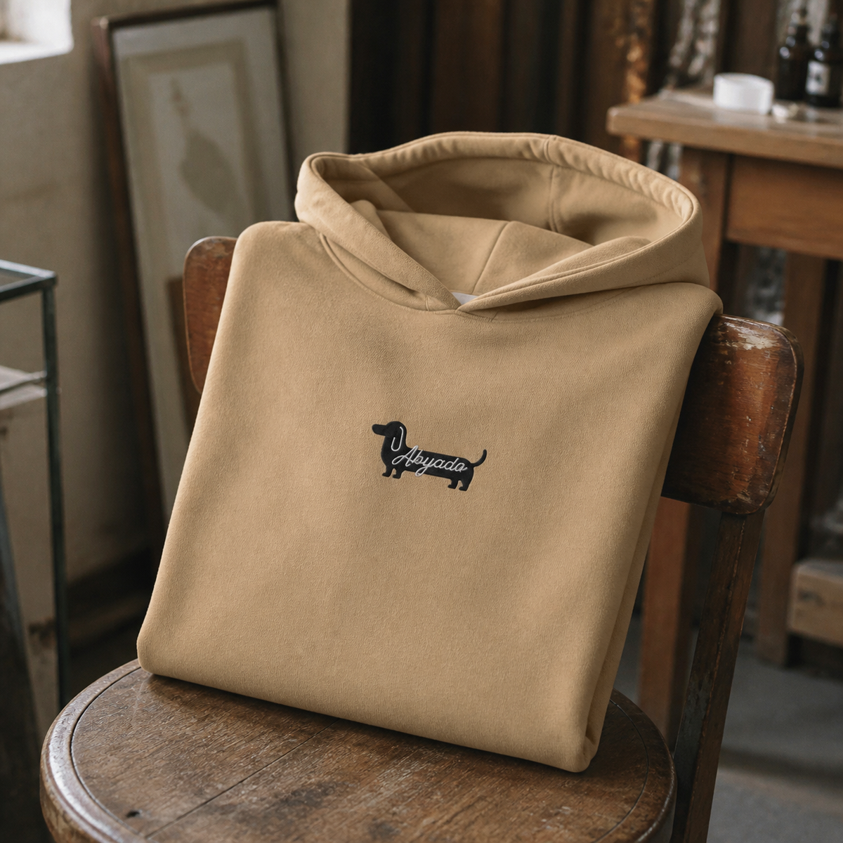 Abyadog Embroidery Hoodie lifestyle detail — Sand