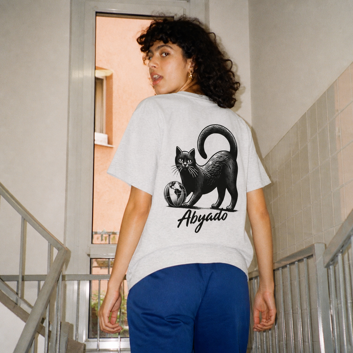 Global Play Tee in White, stairwell lifestyle view